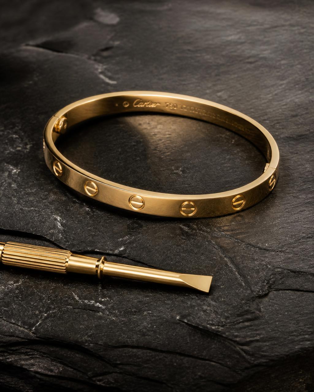 Cartier Love bangle in yellow gold on dark slate